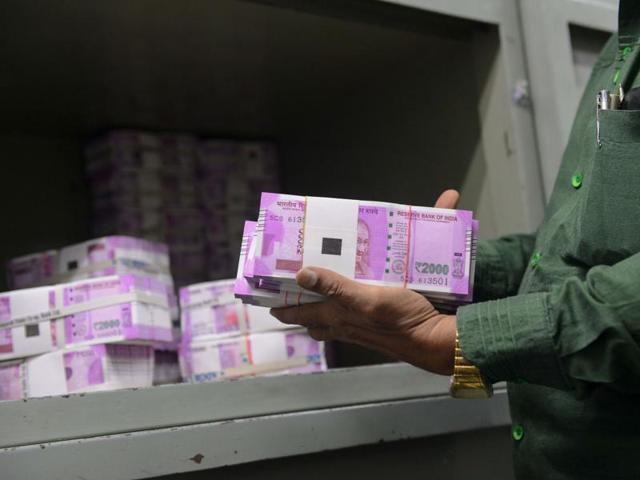 A bank employee checks stacks of new 2000 rupee notes in Ahmedabad.(AFP Photo)