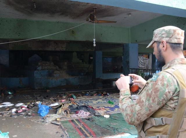 A Pakistani army soldier takes picture of suicide blast site in a shrine of Sufi saint Shah Noorani, some 750 kilometres south of Quetta. (AFP Photo) A Pakistani army soldier takes picture of suicide blast site in a shrine of Sufi saint Shah Noorani, some 750 kilometres south of Quetta. (AFP Photo)