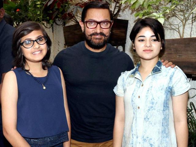 Aamir Khan with Suhani Bhatnagar and Zaria Wasim during the song launch of his upcoming film Dangal in Mumbai. (PTI Photo)