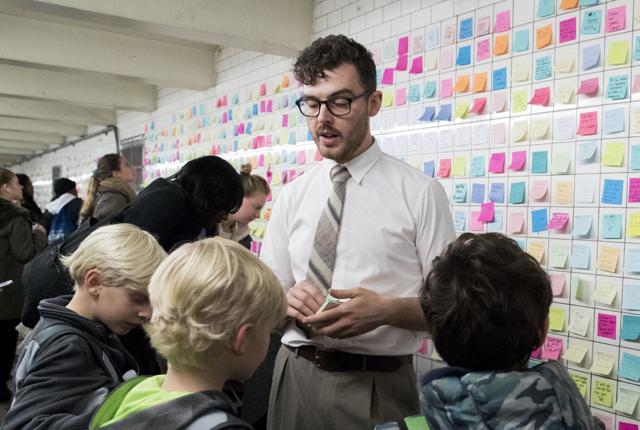 Matthew Chavez, who goes by the artist name Levee, talks to children about the messages posted on the "Subway Therapy" wall. (AP) Matthew Chavez, who goes by the artist name Levee, talks to children about the messages posted on the "Subway Therapy" wall. (AP)