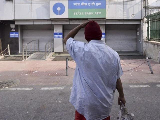 A man stares at a closed SBI ATM on Monday morning in Delhi. In a surprise move, Prime Minister Narendra Modi announced on November 8 that existing 1,000 and 500 rupee were being abolished as legal tender from November 9 in a move to tackle black money. (Arun Sharma/HT Photo) A man stares at a closed SBI ATM on Monday morning in Delhi. In a surprise move, Prime Minister Narendra Modi announced on November 8 that existing 1,000 and 500 rupee were being abolished as legal tender from November 9 in a move to tackle black money. (Arun Sharma/HT Photo)