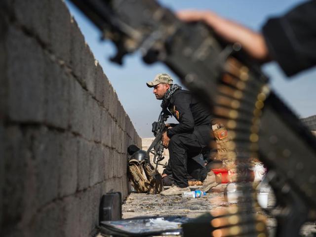 A soldier from the Iraqi Special Forces 2nd division crouches as he takes up a position while his comrades take cover behind a wall on a rooftop, in Mosul on Sunday. (AFP) A soldier from the Iraqi Special Forces 2nd division crouches as he takes up a position while his comrades take cover behind a wall on a rooftop, in Mosul on Sunday. (AFP)