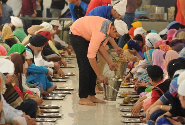 Langar being served to mark birth anniversary of Guru Nanak Dev, in Jalandhar on Monday. (Pardeep Pandit/HT Photo)