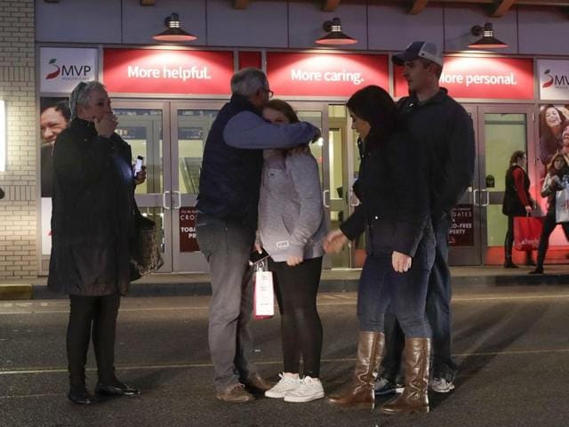 People embrace after leaving Crossgates Mall in Guilderland, New York after reports of gunfire inside on Saturday. The Albany Times-Union says hundreds of people were evacuated and the mall was locked down. (AP)