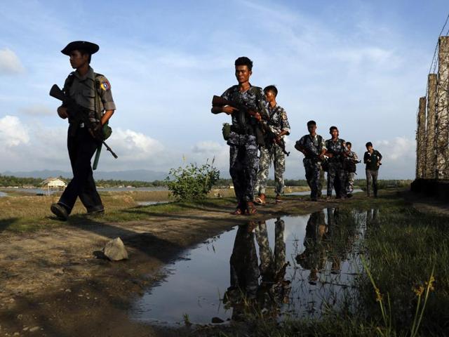 In this file photo, Myanmar police officers patrol along the border fence between Myanmar and Bangladesh in Maungdaw, Rakhine State, Myanmar. (AP Photo) In this file photo, Myanmar police officers patrol along the border fence between Myanmar and Bangladesh in Maungdaw, Rakhine State, Myanmar. (AP Photo)