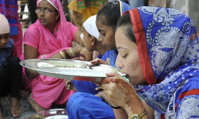 A woman partakes of langar at Gurdwara Nada Sahib in Panchkula on Monday. (Sant Arora/HT Photo)