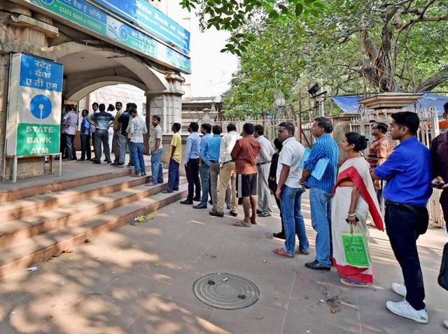 People queue outside a ATM to withdraw money in Siliguri on November 14, 2016.(AFP)