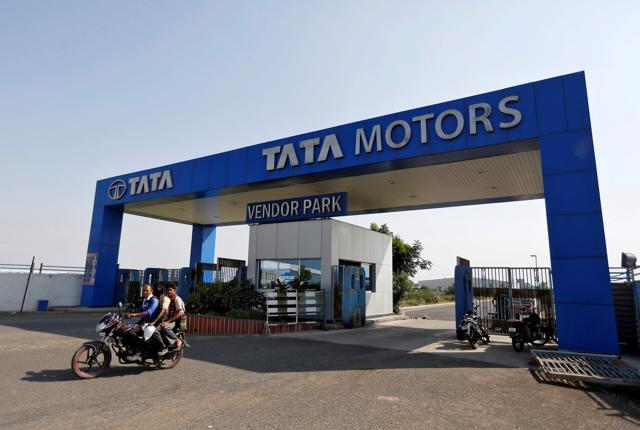 Men ride a motorbike as they come out of a past a Tata Motors car plant at Sanand, Gujarat. (REUTERS) Men ride a motorbike as they come out of a past a Tata Motors car plant at Sanand, Gujarat. (REUTERS)