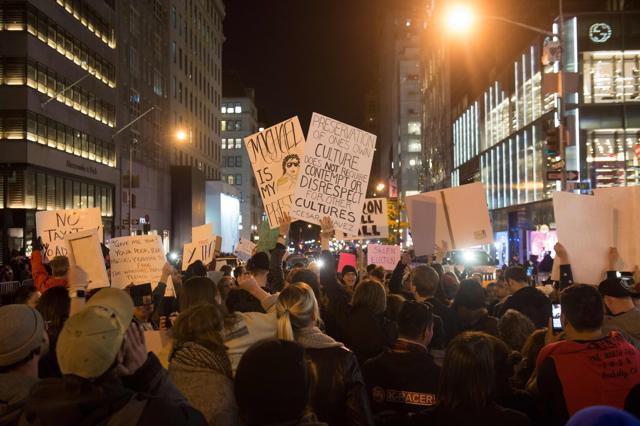 Demonstrators protest against Trump on Fifth Avenue outside Trump Tower on Sunday (AFP) Demonstrators protest against Trump on Fifth Avenue outside Trump Tower on Sunday (AFP)