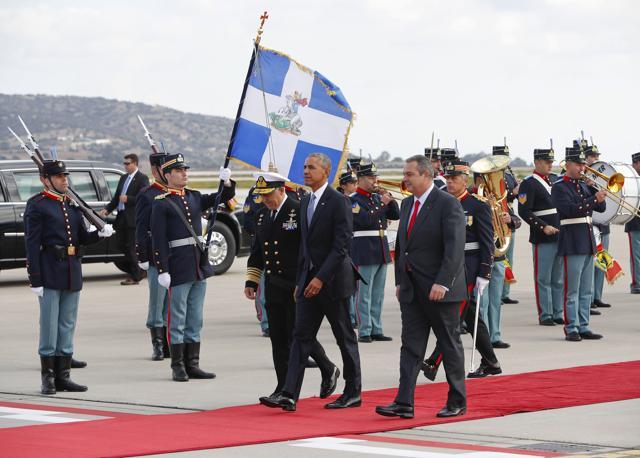 US President Barack Obama, center, walks with Greek National Defense Minister Panos Kommenos, right, during the arrival ceremony at the Athens Eleftherios Venizelos International Airport on Tuesday. (AP) US President Barack Obama, center, walks with Greek National Defense Minister Panos Kommenos, right, during the arrival ceremony at the Athens Eleftherios Venizelos International Airport on Tuesday. (AP)