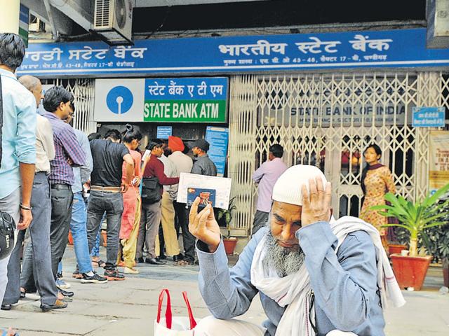 People queued up outside an SBI ATM at Bank Square, Sector 17, in Chandigarh on Monday as an elderly man sits helplessly waiting for his turn to withdraw cash. (Anil Dayal/HT Photo) People queued up outside an SBI ATM at Bank Square, Sector 17, in Chandigarh on Monday as an elderly man sits helplessly waiting for his turn to withdraw cash. (Anil Dayal/HT Photo)