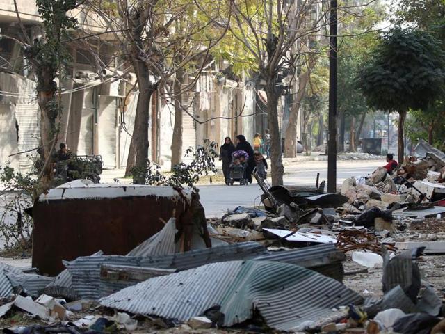 Civilians walk past debris of damaged buildings in the rebel held area of Old Aleppo, Syria on Monday. (Reuters) Civilians walk past debris of damaged buildings in the rebel held area of Old Aleppo, Syria on Monday. (Reuters)
