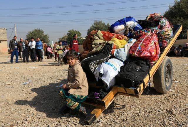 Displaced Iraqis flee from their homes at Shahrezad village east of Mosul, Iraq. (REUTERS) Displaced Iraqis flee from their homes at Shahrezad village east of Mosul, Iraq. (REUTERS)