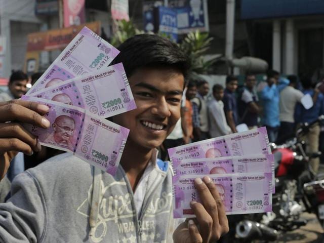 Girls show banned currency notes of 500 and 1000 at the railway station in Allahabad on Monday. (PTI) Girls show banned currency notes of 500 and 1000 at the railway station in Allahabad on Monday. (PTI)