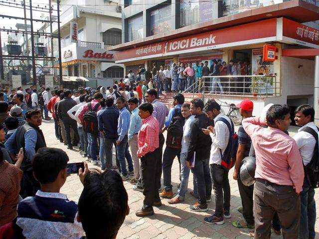People queue outside a bank to exchange and deposit their old high denomination banknotes in Allahabad. (Reuters Photo) People queue outside a bank to exchange and deposit their old high denomination banknotes in Allahabad. (Reuters Photo)