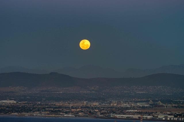 The 'Super' full moon rises above the Table Bay harbour, and the central city in Cape Town. (RODGER BOSCH/AFP) The 'Super' full moon rises above the Table Bay harbour, and the central city in Cape Town. (RODGER BOSCH/AFP)