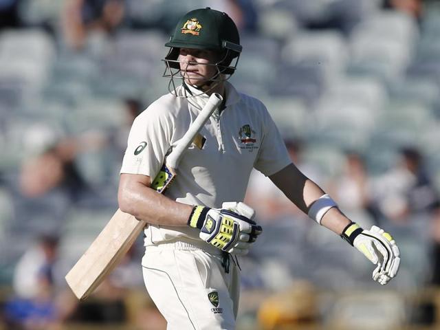 Australia's Steve Smith looks at a replay as he walks from the ground after being dismissed on day four.(AFP Photo)