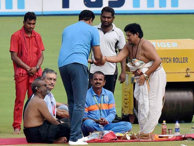 A priest gives ‘prasad’ to India coach Anil Kumble after performing puja ahead of the second Test against England in Visakhapatnam on Wednesday. Kumble would be hoping the divine blessing will help his team to dominate the Test. (PTI)