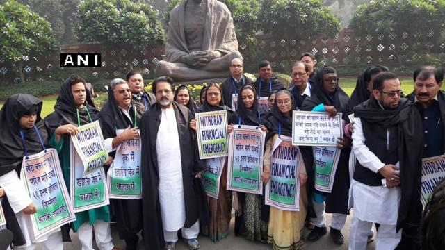 TMC MPs protest against the demonetisation move in front of the Gandhi statue inside the Parliament complex in New Delhi. (ANI Photo) TMC MPs protest against the demonetisation move in front of the Gandhi statue inside the Parliament complex in New Delhi. (ANI Photo)