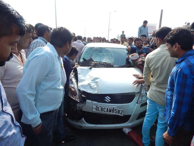 People surround the damaged car. (CL Kashyap/HT Photo) People surround the damaged car. (CL Kashyap/HT Photo)