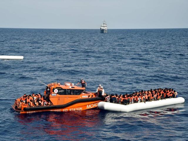 Migrants and refugees on a rubber boat wait to be evacuated during a rescue operation by the crew of the Topaz Responder, a rescue ship run by Maltese NGO "Moas" and the Italian Red Cross, on November 5, 2016 off the coast of Libya.(AFP file photo) Migrants and refugees on a rubber boat wait to be evacuated during a rescue operation by the crew of the Topaz Responder, a rescue ship run by Maltese NGO "Moas" and the Italian Red Cross, on November 5, 2016 off the coast of Libya.(AFP file photo)