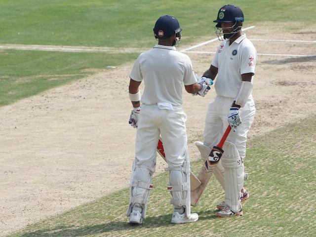 Cheteshwar Pujara of India celebrates his fifty with Virat Kohli.  (BCCI/ SPORTZPICS) 