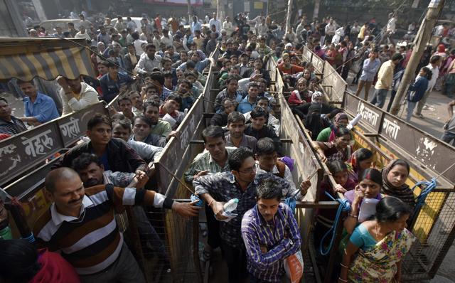 People wait outside a bank in New Delhi to withdraw cash and exchange demonetised banknotes. (Ravi Choudhary/HT Photo) People wait outside a bank in New Delhi to withdraw cash and exchange demonetised banknotes. (Ravi Choudhary/HT Photo)