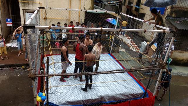 One Bhayander team in the middle of a session inside a cage fashioned from wooden tables, bedsheets and rope