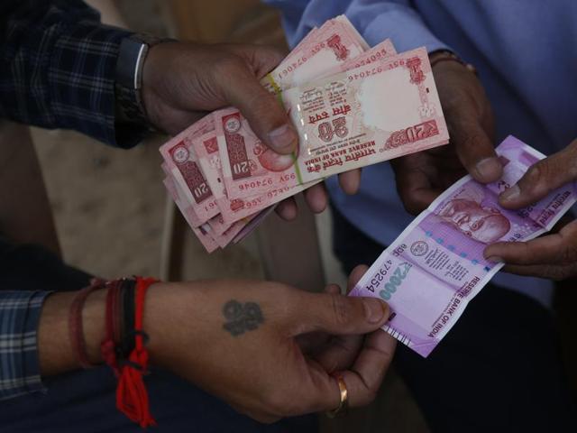 A man gets a Rs 2000 banknote exchanged for smaller notes at a roadside stall, in Ahmadabad. (AP Photo) A man gets a Rs 2000 banknote exchanged for smaller notes at a roadside stall, in Ahmadabad. (AP Photo)