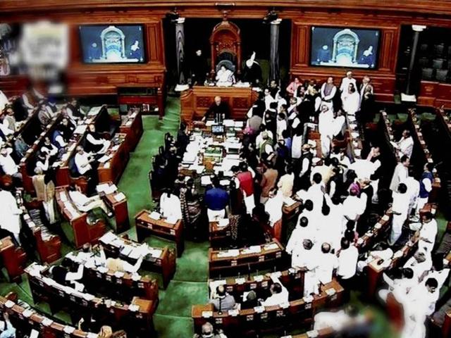 Opposition members protest in the well of Lok Sabha during the winter session of Parliament in New Delhi on Friday.(PTI)