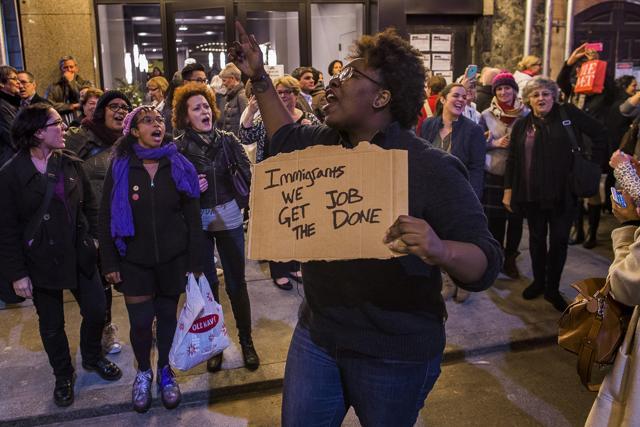 Protesters shout slogans at Vice President-elect Mike Pence as he leaves the Richard Rodgers Theatre after a performance of "Hamilton," in New York.  (AP)