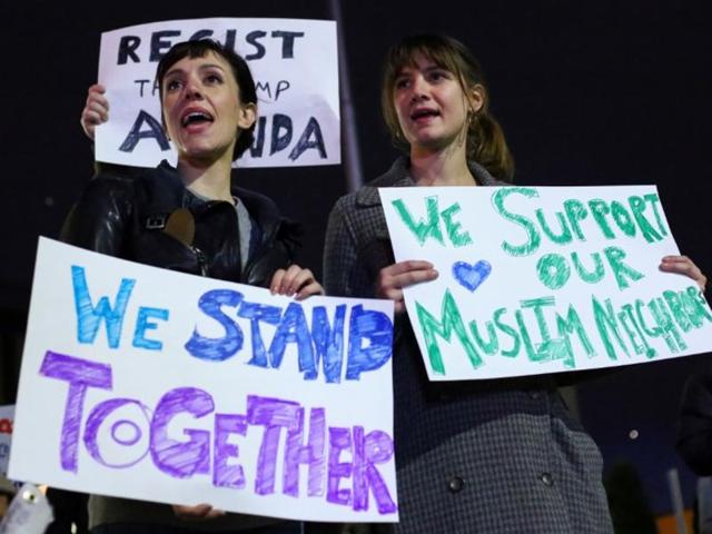 Demonstrators hold signs during a protest against President-elect Donald Trump and in support of Muslims residents in downtown Hamtramck, Michigan, US. (Reuters File Photo) Demonstrators hold signs during a protest against President-elect Donald Trump and in support of Muslims residents in downtown Hamtramck, Michigan, US. (Reuters File Photo)