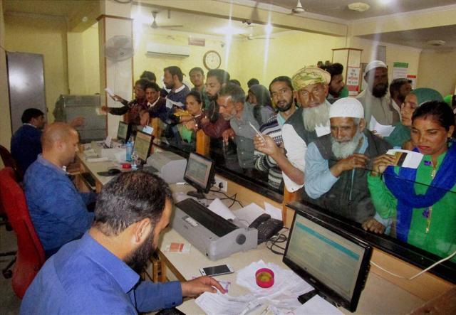 People standing in queues inside the Jammu & Kashmir Bank to deposit and exchange 500 and 1000 rupee notes in Rajouri on Friday. (PTI) People standing in queues inside the Jammu & Kashmir Bank to deposit and exchange 500 and 1000 rupee notes in Rajouri on Friday. (PTI)