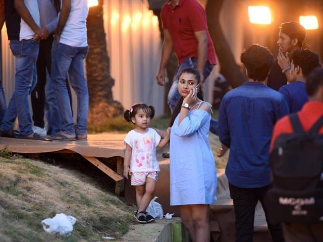 While people get ready to book their spots before the event begins, we caught this concert-goer possibly waiting for her friends with a child, at Bandra-Kurla Complex on Saturday. (Pratik Chorge/HT PHOTO) While people get ready to book their spots before the event begins, we caught this concert-goer possibly waiting for her friends with a child, at Bandra-Kurla Complex on Saturday. (Pratik Chorge/HT PHOTO)
