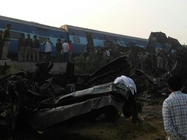Police officials gather next to a derailed coach. (ht photo)