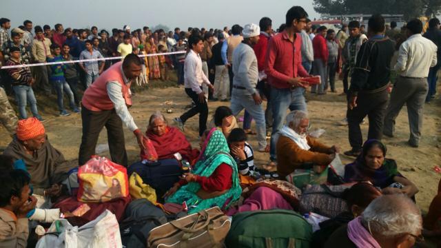 Passengers wait near the accident site. (HT Photo) Passengers wait near the accident site. (HT Photo)