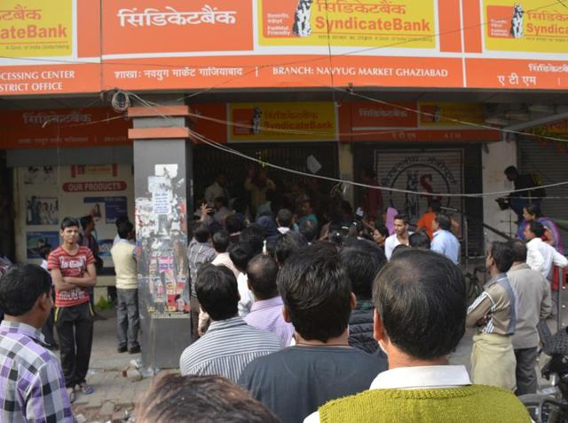 People standing outside a bank in Ghaziabad, November 19, 2016. According to a report, people who deposit their unaccounted old currency in someone else’s bank account will be prosecuted by the I-T department.(Sakib Ali / HT Photo)