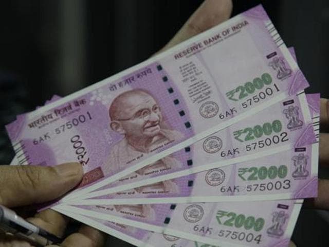 A man shows new Rs 2000 banknotes he received after exchanging demonetised notes in Jammu.(AP Photo) A man shows new Rs 2000 banknotes he received after exchanging demonetised notes in Jammu.(AP Photo)