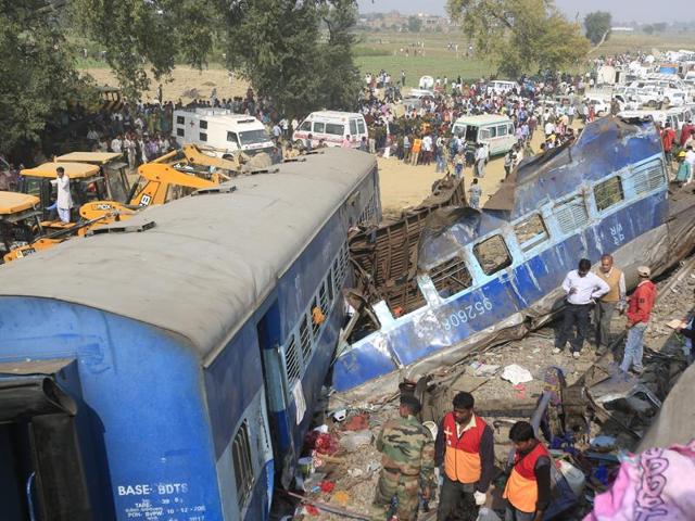 Rescue workers search for survivors at the site of a train derailment in Kanpur Dehat district.(HT Photo)