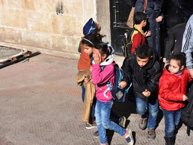 Schoolchildren evacuate a school after shelling by Syrian rebels on government-held western Aleppo, Syria on Sunday. (REUTERS) Schoolchildren evacuate a school after shelling by Syrian rebels on government-held western Aleppo, Syria on Sunday. (REUTERS)
