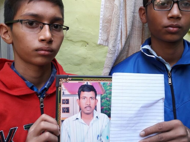 Karambir (Left) and Hitesh show their father’s photograph at their home in Kheri Sampla in Rohtak.(HT Photo) Karambir (Left) and Hitesh show their father’s photograph at their home in Kheri Sampla in Rohtak.(HT Photo)