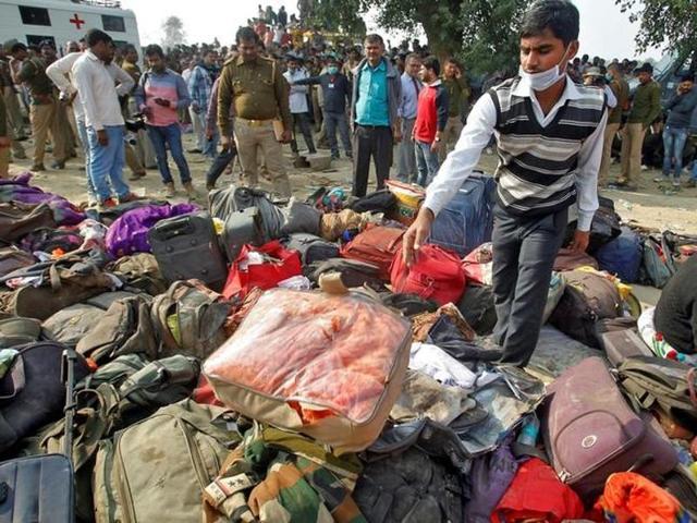 A man sorts through luggage at the site of the train accident in Pukhrayan, Kanpur.(Reuters Photo)