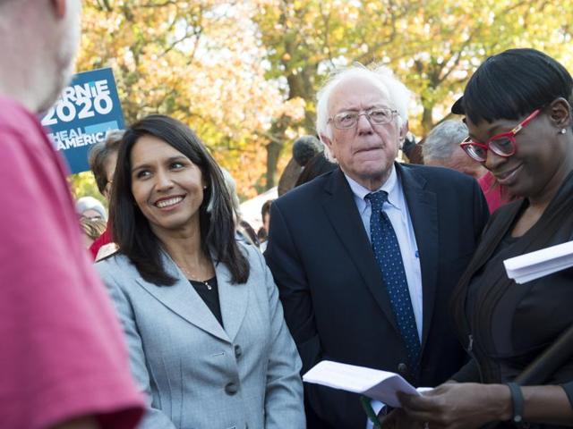 Tulsi Gabbard (left) with Bernie Sanders during a rally to stop the Trans-Pacific Partnership on November 17. (AFP) Tulsi Gabbard (left) with Bernie Sanders during a rally to stop the Trans-Pacific Partnership on November 17. (AFP)