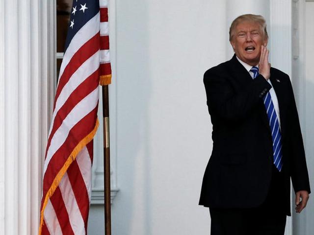 US president-elect Donald Trump yells to members of the media from the steps of the main clubhouse at Trump National Golf Club in Bedminster. (Reuters Photo) US president-elect Donald Trump yells to members of the media from the steps of the main clubhouse at Trump National Golf Club in Bedminster. (Reuters Photo)