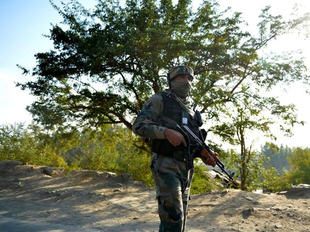 An Indian Army soldier looks on after two suspected militants were killed in a gunbattle in Pampore, south of Srinagar, on October 12.(AFP File)