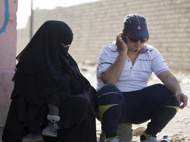 In this photo, a man who identified himself as Omar Danoun talks on the phone during an interview with The Associated press in Gogjali, Iraq. Danoun was taken into custody later in the interview by Iraqi soldiers who overheard and said he seemed to have a Syrian Accent, and who believed he was an Islamic Stage group member. (AP Photo) In this photo, a man who identified himself as Omar Danoun talks on the phone during an interview with The Associated press in Gogjali, Iraq. Danoun was taken into custody later in the interview by Iraqi soldiers who overheard and said he seemed to have a Syrian Accent, and who believed he was an Islamic Stage group member. (AP Photo)