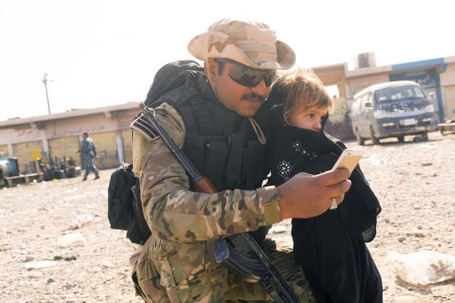 An Iraqi Soldier takes a selfie with the daughter of a man who identified himself as Omar Danoun at a collection point for people displaced by fighting in Mosul, in Gogjali, Iraq. (AP Photo) An Iraqi Soldier takes a selfie with the daughter of a man who identified himself as Omar Danoun at a collection point for people displaced by fighting in Mosul, in Gogjali, Iraq. (AP Photo)