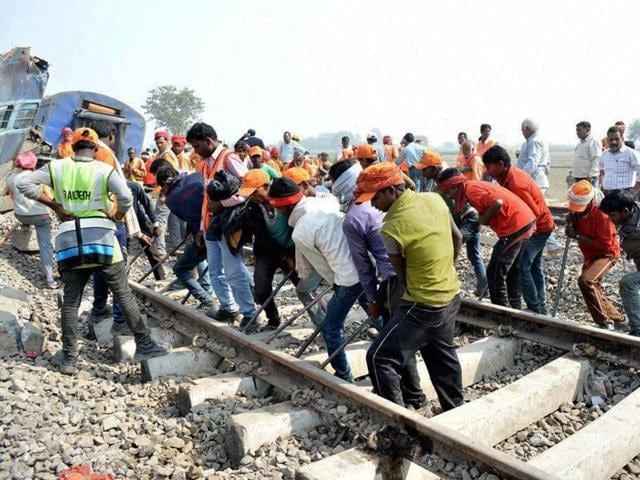 Rescuers and relief works in progress at the site of accident where Patna-Indore Express train derailed near Pukhrayan village in Kanpur Dehat district on Monday.(PTI)