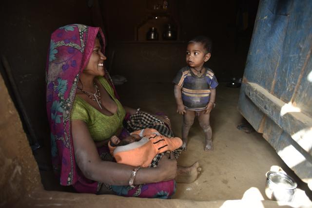 Halki’s baby boy Anand was born at home at 2 am but the umbilical cord was cut eight hours later because her husband Vishnu Adivasi, 30, could not get a midwife. She has three babies and has lost another three to malnutrition in Bhairopura village in Madhya Pradesh’s Shivpuri district. (Virendra Singh Gosain/Hindustan Times)