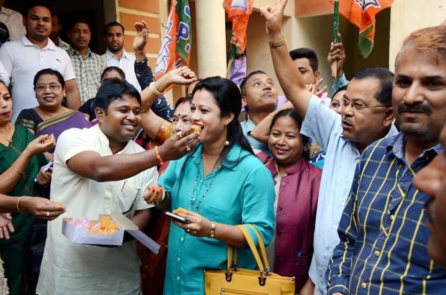 BJP workers celebrate the win of party candidates from Lakhimpur Lok Sabha seat and Boithalangsu assembly seat, in Guwahati on Tuesday. (PTI)